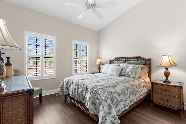 bedroom featuring a ceiling fan, baseboards, wood finished floors, and lofted ceiling