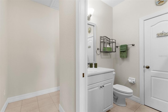 bathroom with vanity, baseboards, toilet, and tile patterned floors
