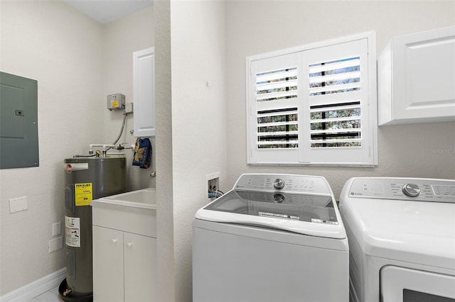 clothes washing area featuring water heater, electric panel, cabinet space, and washer and clothes dryer