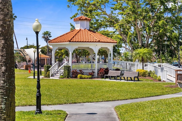 surrounding community with a yard, a gazebo, and fence