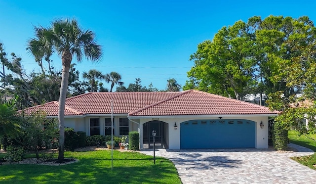 316 Signorelli Dr, Nokomis, FL 34275 - mediterranean / spanish-style house with an attached garage, a front lawn, stucco siding, and a tiled roof