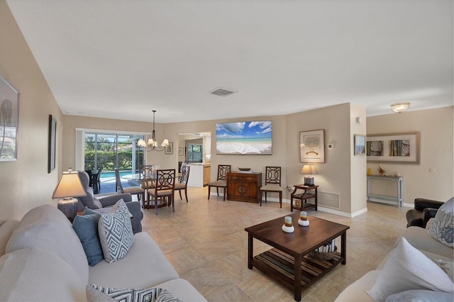 316 Signorelli Dr, Nokomis, FL 34275 - living area featuring visible vents, baseboards, and a chandelier