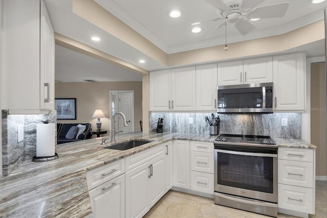 316 Signorelli Dr, Nokomis, FL 34275 - kitchen with decorative backsplash, a sink, light stone counters, stainless steel appliances, and recessed lighting