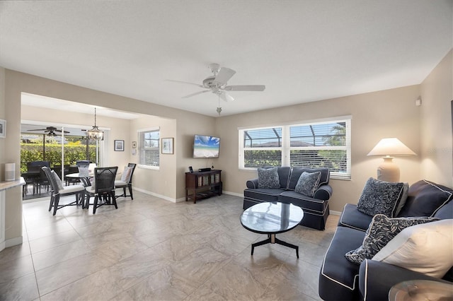 316 Signorelli Dr, Nokomis, FL 34275 - living room with baseboards, plenty of natural light, and ceiling fan with notable chandelier