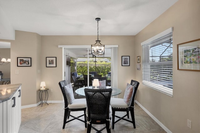 316 Signorelli Dr, Nokomis, FL 34275 - dining area with baseboards, a notable chandelier, and a healthy amount of sunlight