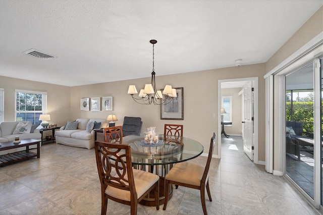 316 Signorelli Dr, Nokomis, FL 34275 - dining room featuring baseboards, a wealth of natural light, a notable chandelier, and visible vents
