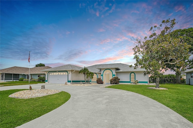 447 Rotonda Cir, Rotonda West, FL 33947 - ranch-style home with stucco siding, concrete driveway, a lawn, and a garage