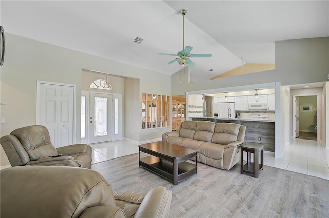447 Rotonda Cir, Rotonda West, FL 33947 - living area featuring a ceiling fan, high vaulted ceiling, light tile patterned floors, and baseboards