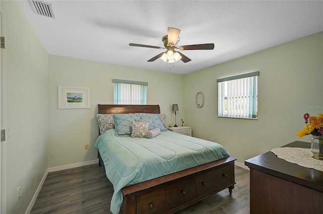 447 Rotonda Cir, Rotonda West, FL 33947 - bedroom with multiple windows, dark wood-style floors, and baseboards