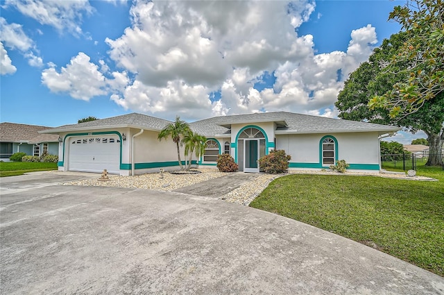 447 Rotonda Cir, Rotonda West, FL 33947 - ranch-style house with stucco siding, an attached garage, and driveway