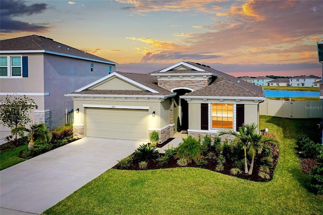 5222 Granite Dust Pl, Palmetto, FL 34221 - view of front of property with a garage, stucco siding, a yard, and stone siding