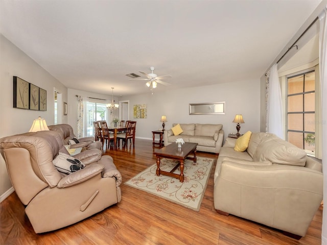 455 Rubens Dr E, Nokomis, FL 34275 - living room featuring wood finished floors, a chandelier, baseboards, and ceiling fan