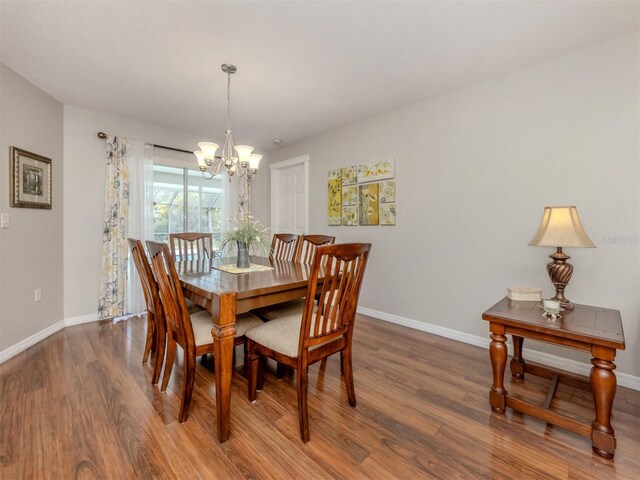 455 Rubens Dr E, Nokomis, FL 34275 - dining space featuring a chandelier, wood finished floors, and baseboards