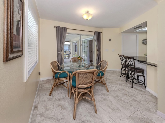 455 Rubens Dr E, Nokomis, FL 34275 - dining room featuring baseboards and light stone finish flooring