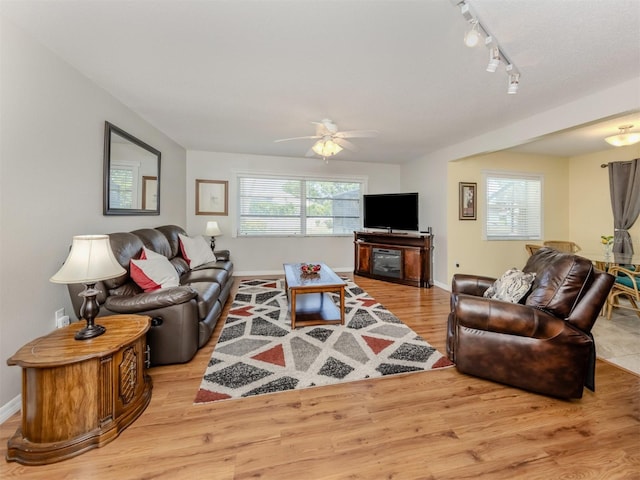 455 Rubens Dr E, Nokomis, FL 34275 - living room featuring light wood-style flooring, a ceiling fan, baseboards, and track lighting