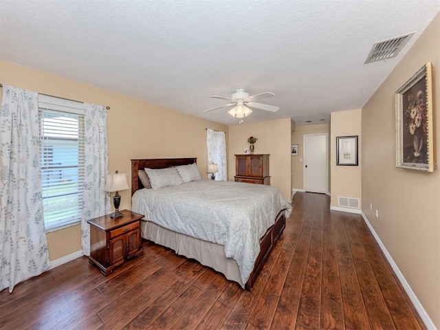 455 Rubens Dr E, Nokomis, FL 34275 - bedroom with dark wood finished floors, baseboards, a textured ceiling, and ceiling fan