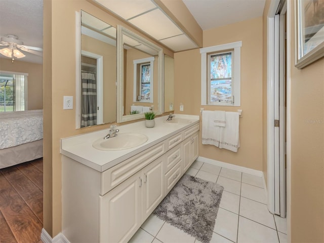 455 Rubens Dr E, Nokomis, FL 34275 - full bath with ceiling fan, baseboards, double vanity, connected bathroom, and tile patterned flooring