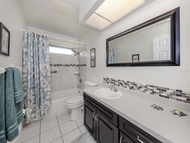 455 Rubens Dr E, Nokomis, FL 34275 - bathroom featuring tile patterned floors, vanity, toilet, shower / bathtub combination with curtain, and decorative backsplash
