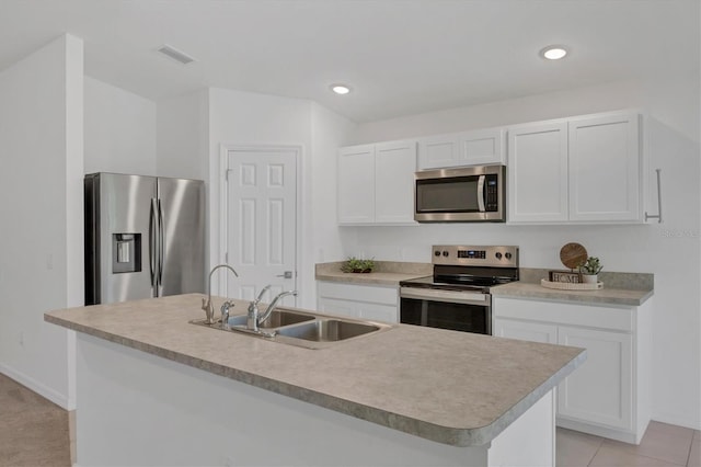 2032 Jagust Rd, North Port, FL 34288 - kitchen featuring visible vents, a center island with sink, white cabinets, a sink, and appliances with stainless steel finishes