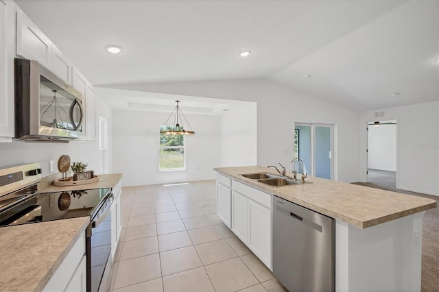 2032 Jagust Rd, North Port, FL 34288 - kitchen with appliances with stainless steel finishes, vaulted ceiling, a sink, light countertops, and white cabinetry