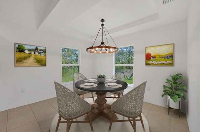 2032 Jagust Rd, North Port, FL 34288 - dining area with light tile patterned floors, baseboards, a tray ceiling, and a chandelier