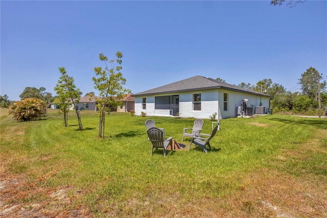 2032 Jagust Rd, North Port, FL 34288 - back of property with central AC, stucco siding, and a yard