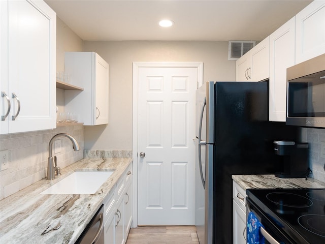 kitchen with visible vents, a sink, white cabinetry, and appliances with stainless steel finishes