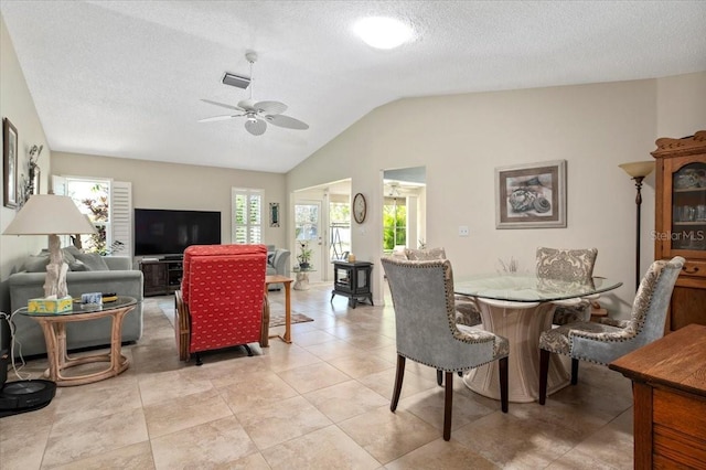 657 Foxwood Blvd, Englewood, FL 34223 - dining space with healthy amount of natural light, a ceiling fan, vaulted ceiling, and a textured ceiling