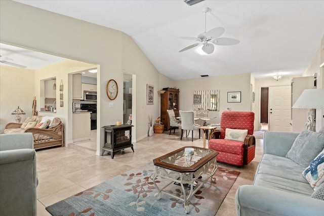 657 Foxwood Blvd, Englewood, FL 34223 - living area with ceiling fan, a wood stove, lofted ceiling, and light tile patterned flooring