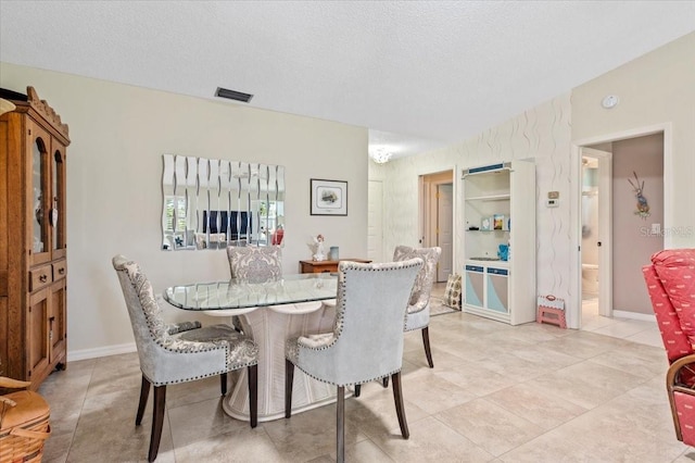 657 Foxwood Blvd, Englewood, FL 34223 - dining room featuring light tile patterned floors and a textured ceiling