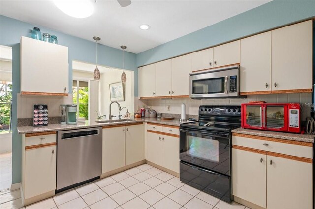 657 Foxwood Blvd, Englewood, FL 34223 - kitchen featuring stainless steel appliances, light countertops, tasteful backsplash, hanging light fixtures, and recessed lighting