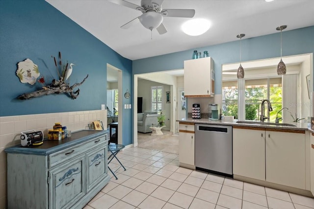 657 Foxwood Blvd, Englewood, FL 34223 - kitchen with dishwasher, a ceiling fan, light tile patterned floors, and hanging light fixtures