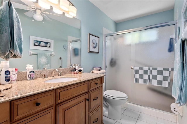 657 Foxwood Blvd, Englewood, FL 34223 - full bath with vanity, a stall shower, ceiling fan, and tile patterned floors
