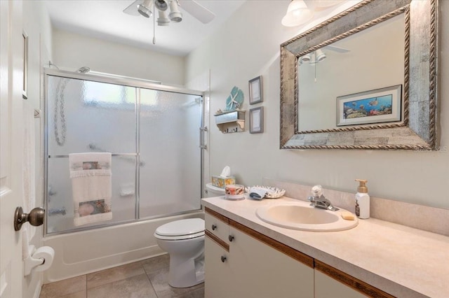 657 Foxwood Blvd, Englewood, FL 34223 - full bathroom with vanity, combined bath / shower with glass door, ceiling fan, and tile patterned floors