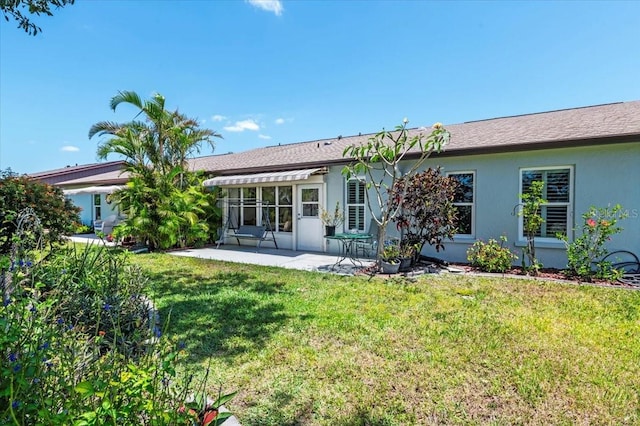 657 Foxwood Blvd, Englewood, FL 34223 - back of property with a patio, stucco siding, and a lawn