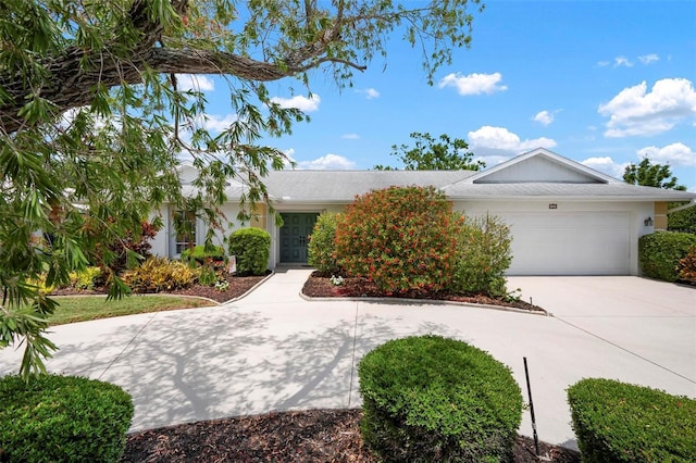 view of front of house featuring concrete driveway and an attached garage