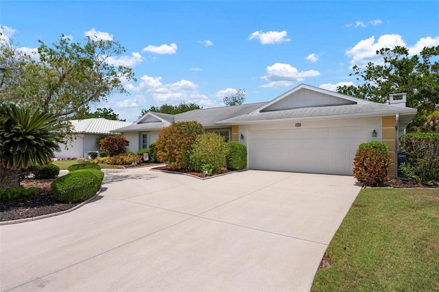 single story home featuring driveway and a garage