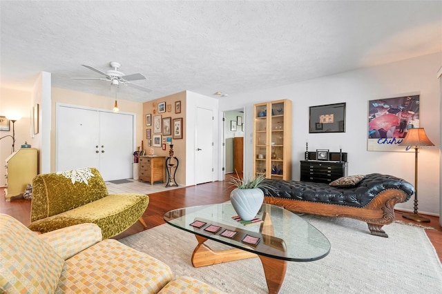 living area featuring wood finished floors and a ceiling fan