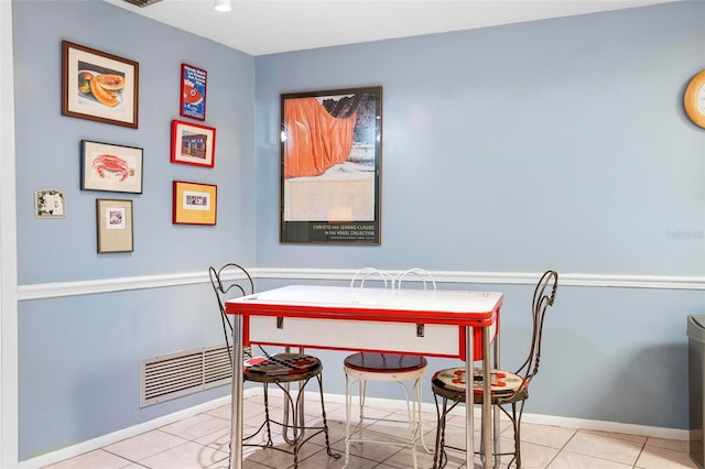 dining area featuring baseboards, visible vents, and tile patterned floors