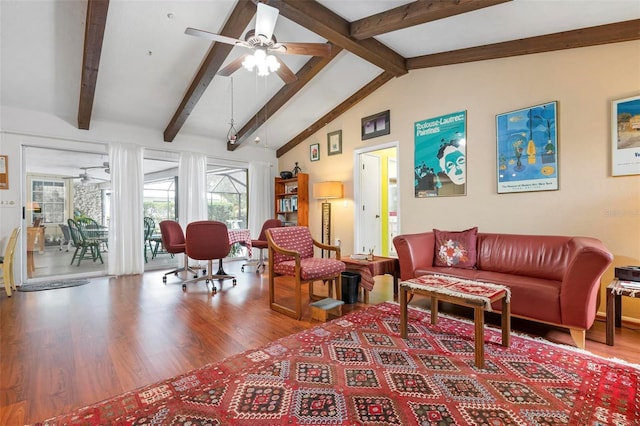 living room with wood finished floors, a ceiling fan, and lofted ceiling with beams