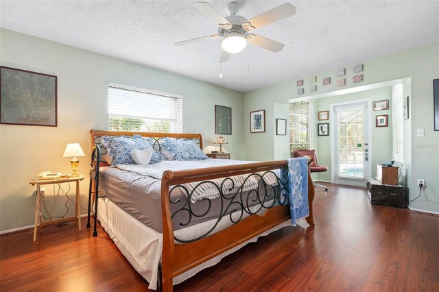 bedroom featuring a ceiling fan, access to exterior, a textured ceiling, and wood finished floors