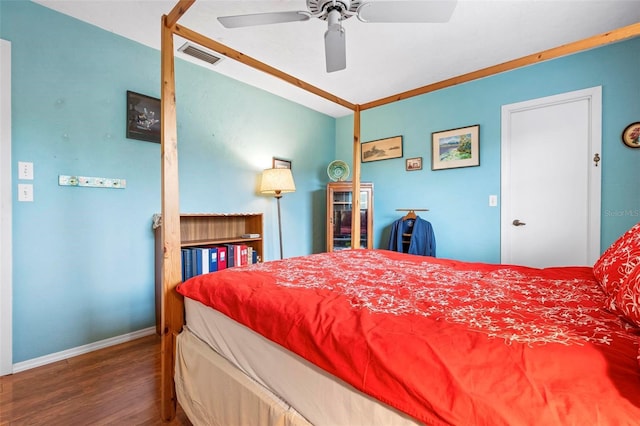 bedroom featuring visible vents, wood finished floors, baseboards, and ceiling fan