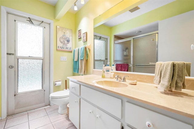 bathroom with a healthy amount of sunlight, tile patterned floors, visible vents, a shower stall, and vanity