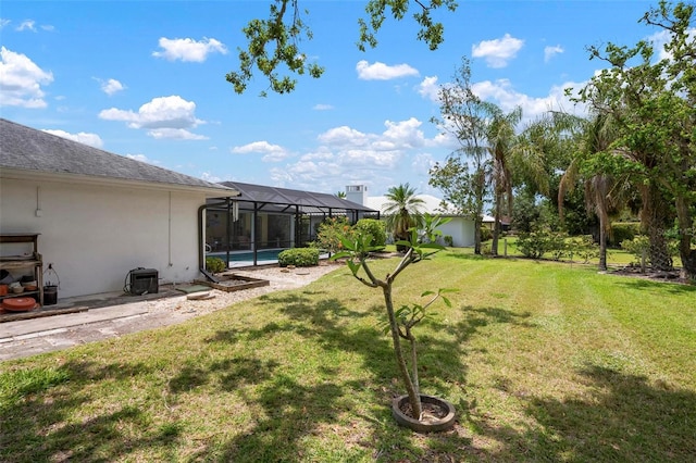 view of yard with a pool and a lanai