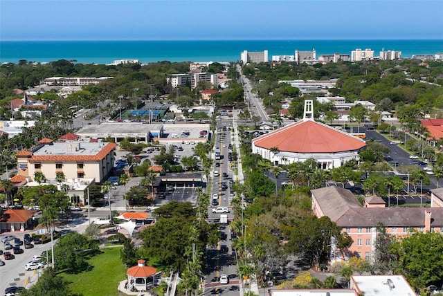 birds eye view of property with a water view and a city view