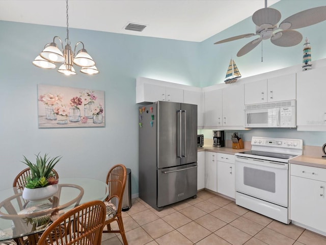 kitchen featuring visible vents, light countertops, light tile patterned floors, ceiling fan with notable chandelier, and white appliances