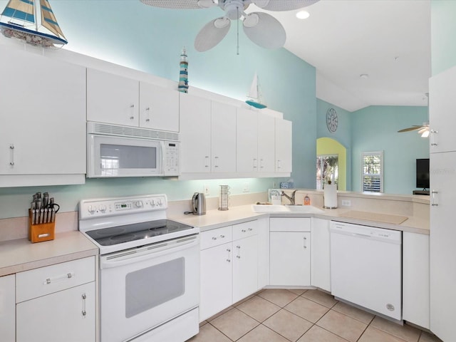 kitchen with lofted ceiling, white appliances, ceiling fan, light countertops, and light tile patterned floors
