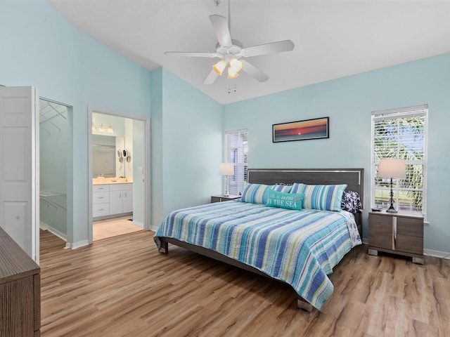 bedroom featuring baseboards, light wood-style flooring, ceiling fan, and vaulted ceiling