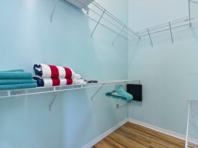 walk in closet with wood finished floors and visible vents