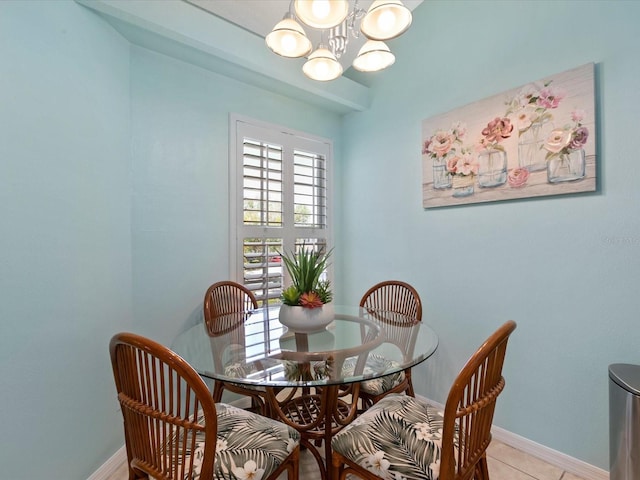 dining space featuring baseboards, a chandelier, and light tile patterned floors